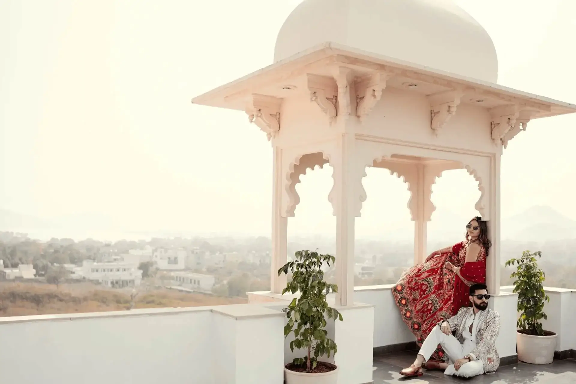 Indian bride wearing a contemporary embroidered lehenga alongside a groom in a traditional sherwani with modern wedding styling