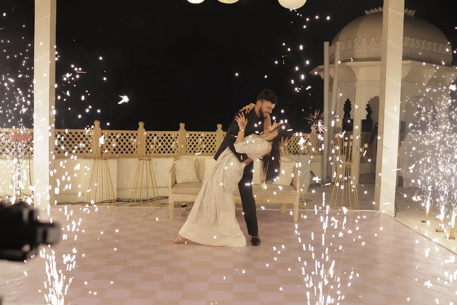 Wedding photographer capturing a candid moment between an Indian bride and groom during their wedding celebration